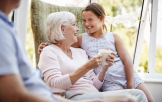 young girl with arm around an older woman