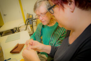 Buena Vida Estates resident making crafts with staff member