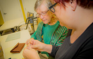 Buena Vida Estates resident making crafts with staff member