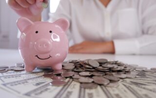 people inserting coin in Piggybank with coins and money over the