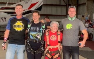 margaret and her granddaughter with skydiving instructors