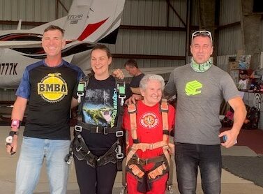 margaret and her granddaughter with skydiving instructors