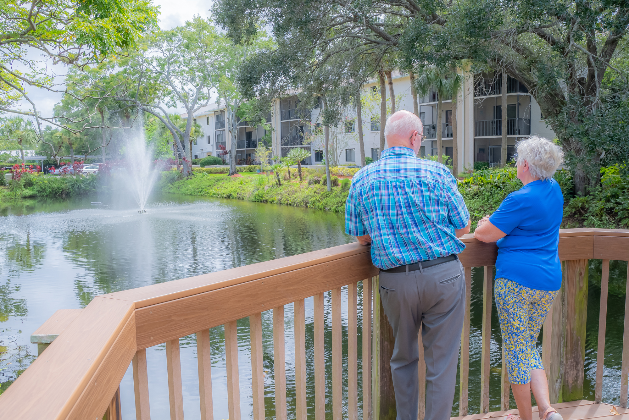 a man and women look out upon a lake with a fountain - Neighbors become life-long friends!