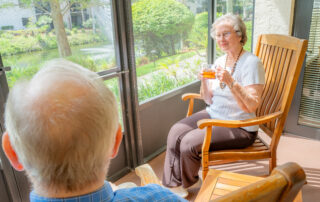 smiling residents sitting on patio