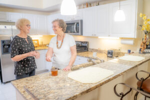 friends smiling in kitchen