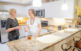 friends smiling in kitchen